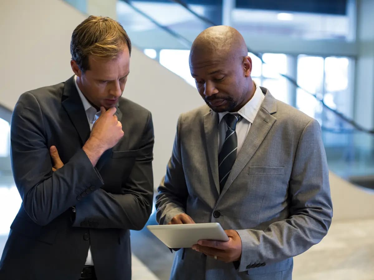 Two business colleagues reviewing information on a tablet